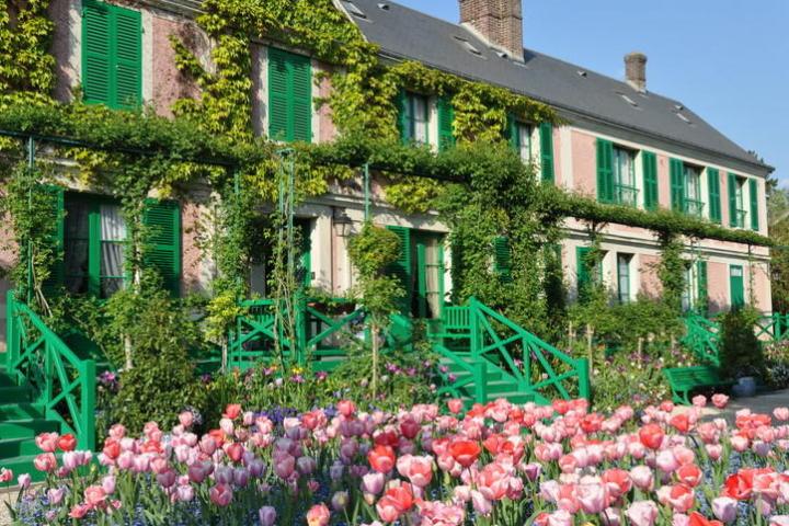 a colorful flower garden in front of a building