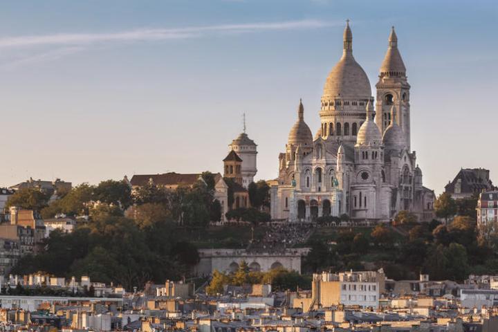 a large building towers over a city