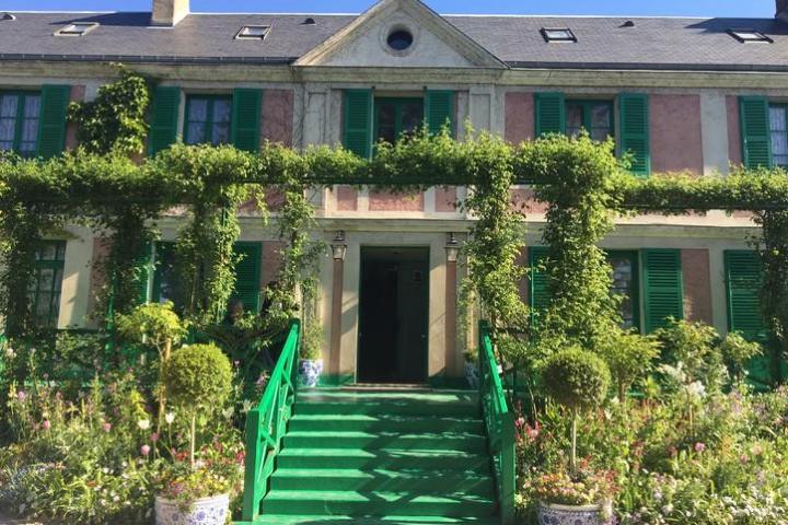 a house with bushes in front of a building